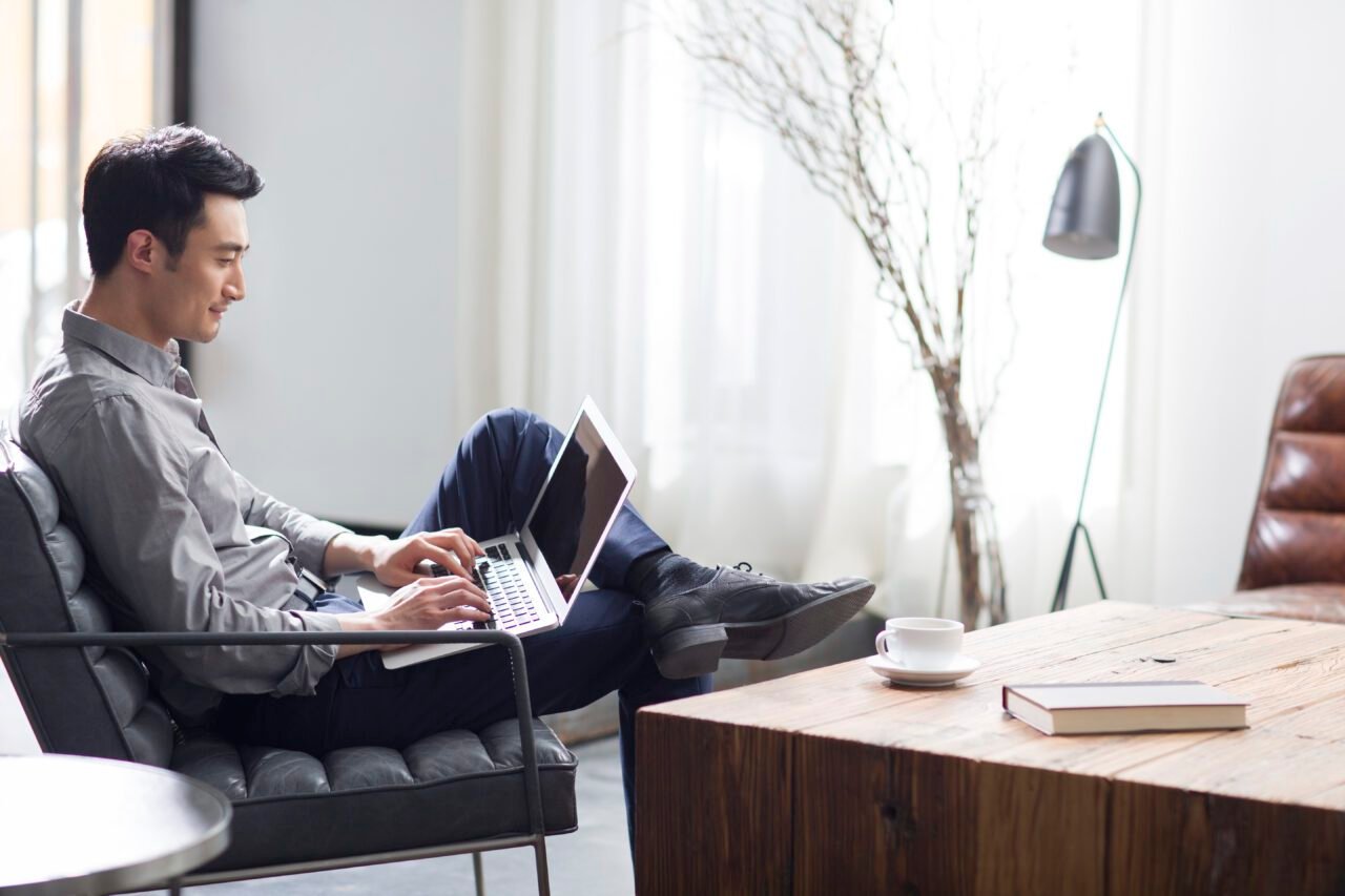 Young man working with laptop in office