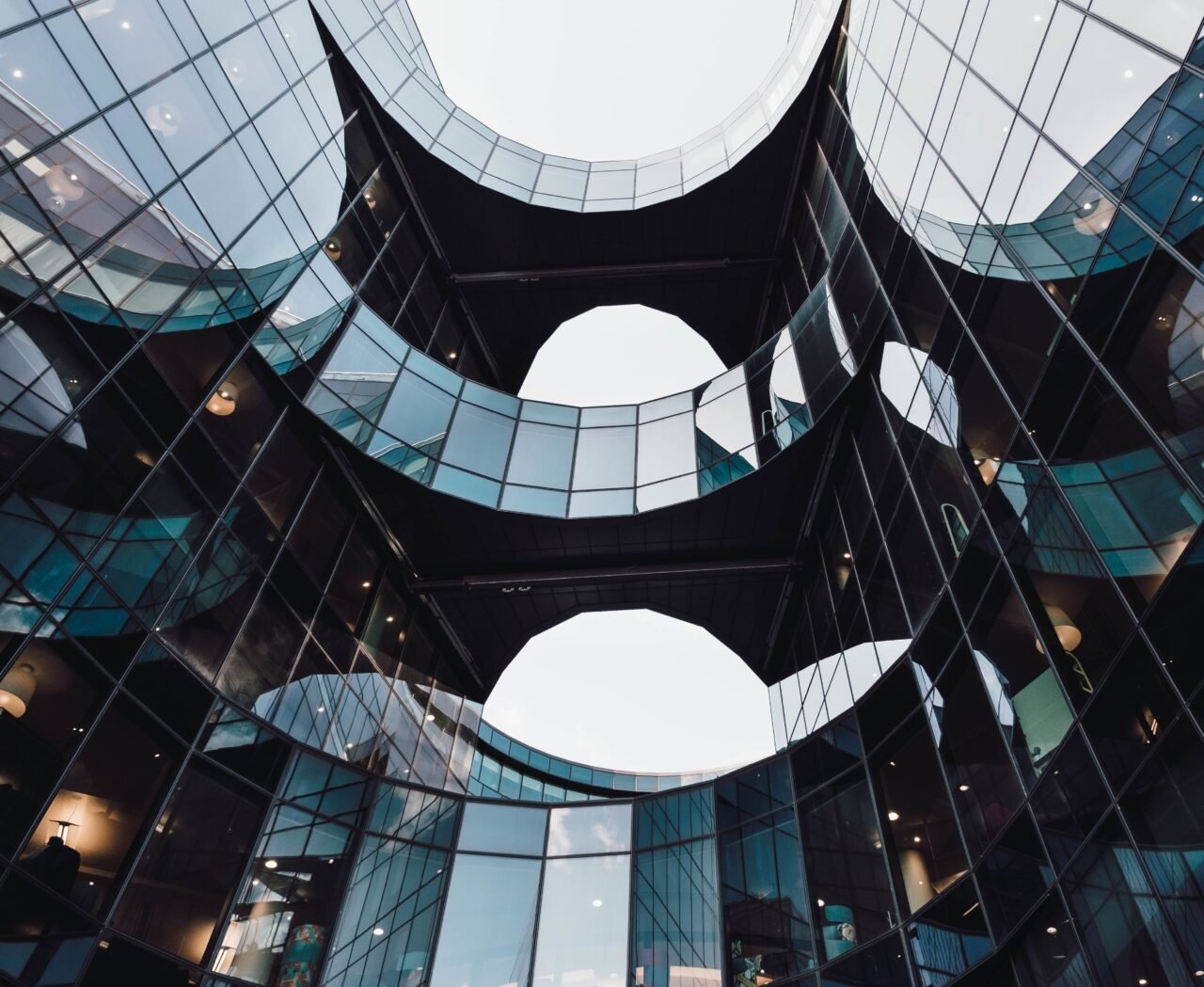 low-angle-shot-of-modern-design-of-an-architectural-building-with-reflections-on-a-glass-window.jpg