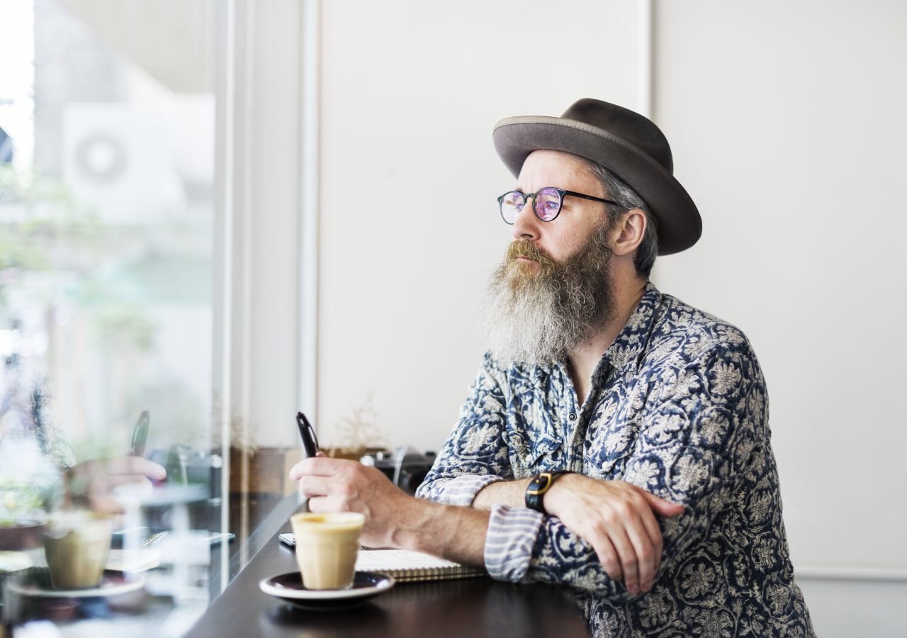 An author making notes in a coffee shop