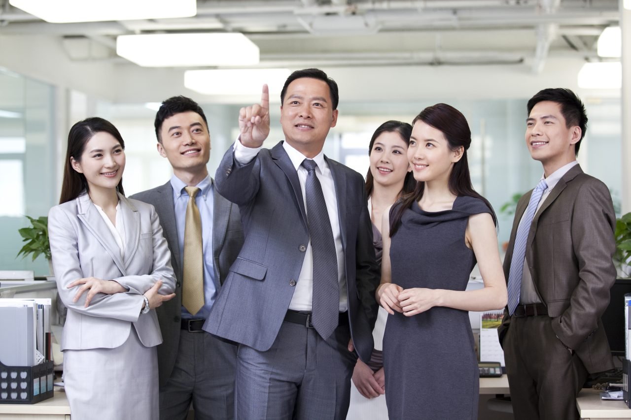Happy businesspeople pressing on a virtual screen