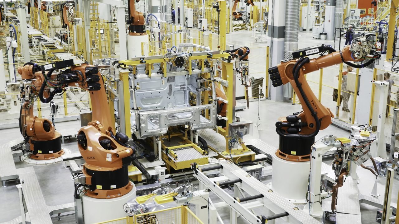 Latest technology in machine production. Scene. Robotic machines working in production of cars and