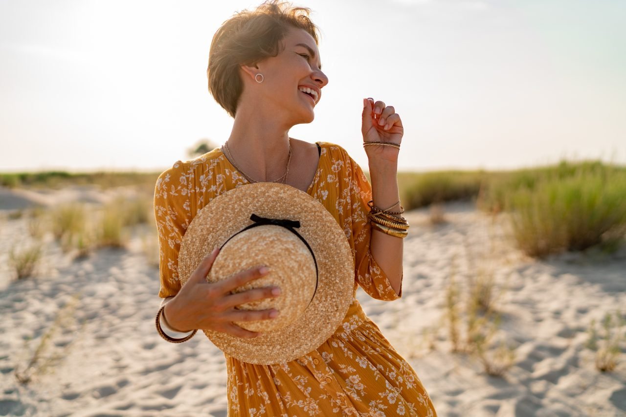 stylish attractive slim smiling woman on beach in summer style fashion trend outfit
